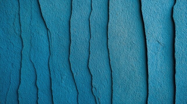 Textured blue wallpaper with subtle grooves offers a modern, calming aesthetic, perfect for backgrounds in design, interior decor, and creative projects,