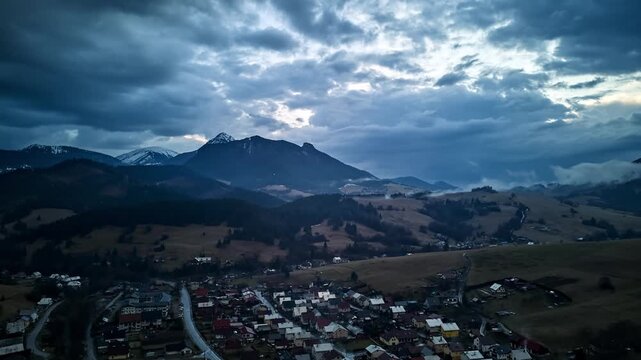 Aerial hyperlapse of a scenic mountain village and moving clouds