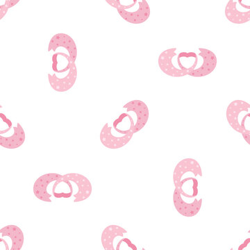 Seamless pattern of pink pacifiers with polka dots isolated on a transparent background