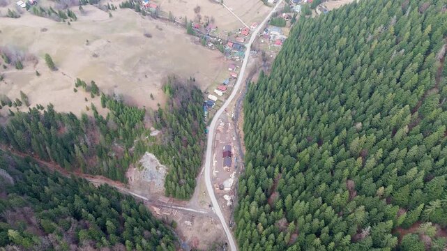 Aerial View of Winding Road in Carpathian Mountain Valley with Rocky Slopes