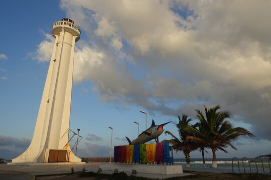 Mahahual Town Sign and Lighthouse at Golden Hour, Mexico
