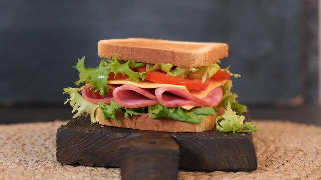 Spinning deli sandwich on wooden board, food rotation video