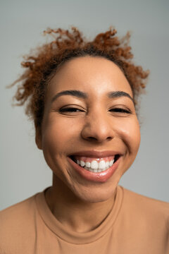 Joyful young woman with a radiant smile enjoying a moment of happiness indoors