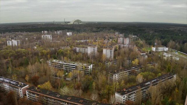 Aerial view of the abandoned city of Pripyat, with the Chernobyl nuclear power plant on the horizon