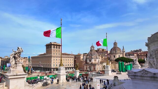 Italian national flags waving over the historic square and architectural landmarks of Rome on a sunny day