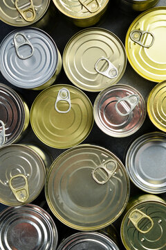 Aluminum cans with canned goods. A large set of canned goods in cans. On a gray background.