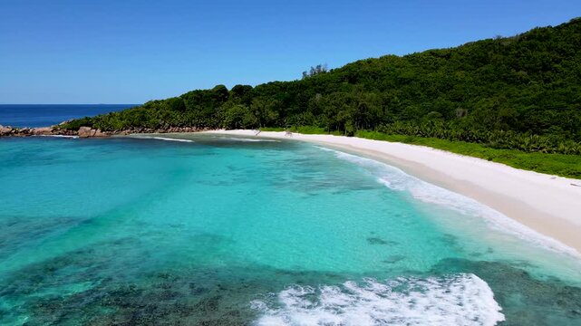 Discover the stunning turquoise waters and soft white sands of Anse Cocos beach on La Digue Island. The serene atmosphere invites visitors to relax and enjoy a peaceful day in paradise Seychelles.