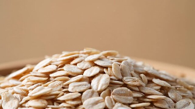 Dry organic oatmeal flakes stacked in a heap cinematic macro style