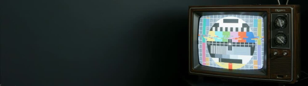 Vintage television displaying a standard test pattern on its screen, presenting concepts of broadcast signal and retro media.