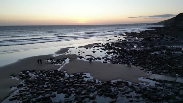 4K Fly‑Away Aerial Drone Shot of Dunraven Bay at Sunset Featuring the Coastline