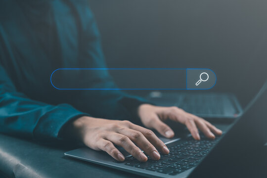 Businesswoman using laptop with blank search bar, representing internet browsing, data search, SEO optimization, networking, and digital information management in office setting.