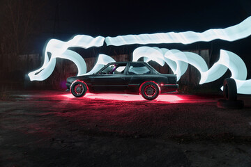 drift powerful car in an old body with black extension and bottom lighting night photography with long exposure © yurii oliinyk