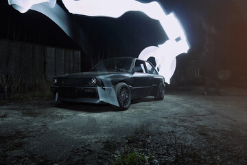 drift powerful car in an old body with black extension and bottom lighting night photography with long exposure © yurii oliinyk