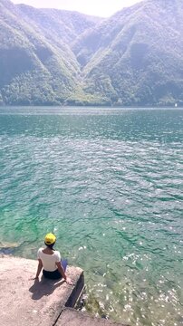 Woman Sitting on Pier by Calm Lake, Peaceful Nature Scene for Wellness, Meditation, Travel and Lifestyle Background with Copy Space