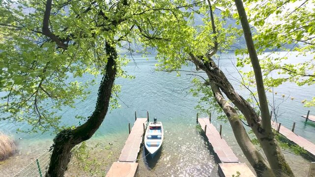 Calm Lake with Small Pier and Boats, Peaceful Forest Nature Landscape, Relaxing Background for Travel, Wellness, Meditation