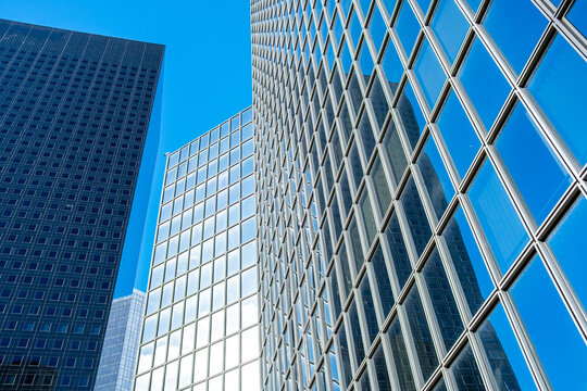 Pattern geometry on a facade architecture for business finance in urban Paris La Defense with glass grid lines and modern abstract texture