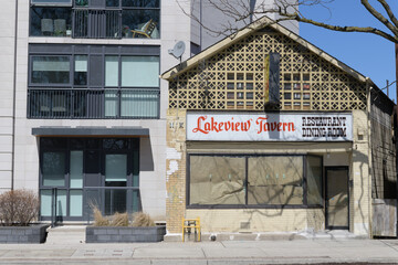Naklejka premium condominium and historic facade and ghost sign of Lakeview Tavern Restaurant Dining Room, located at 1400 Kingston Rd, Toronto