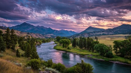 Fototapeta premium Dramatic Sunset over a Winding River in a Mountain Valley