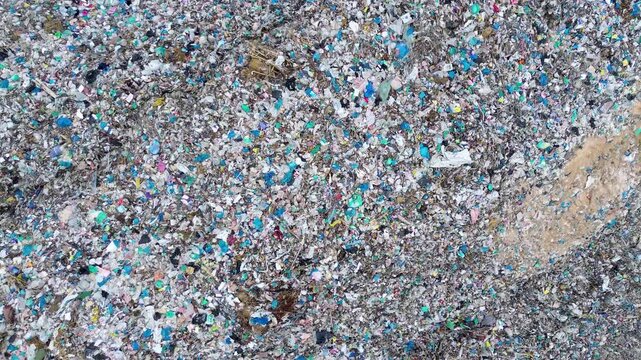 Plastic waste texture at landfill from above representing environmental crisis and pollution aerial