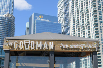 Naklejka premium close-up of sign outside The Goodman Pub and Kitchen located at 207 Queens Quay W, inside Queen's Quay Terminal, Harbourfront Centre area, Toronto
