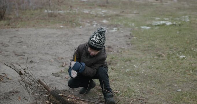 Men with kid cut branches in backyard and stockpile firewood in shed for winter. 4K 10-bit