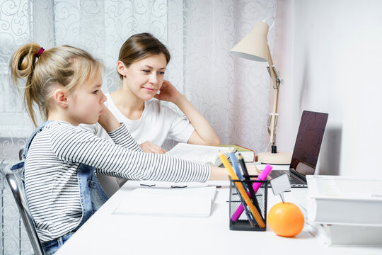 Mother and daughter doing homework together, styding and learning concept, doing tasks for school