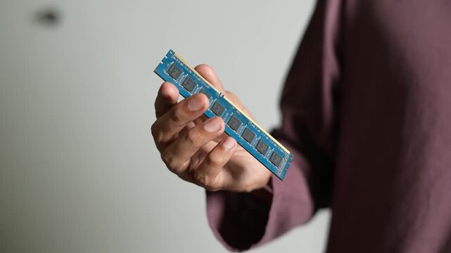 Hand Holding Computer RAM Close-Up