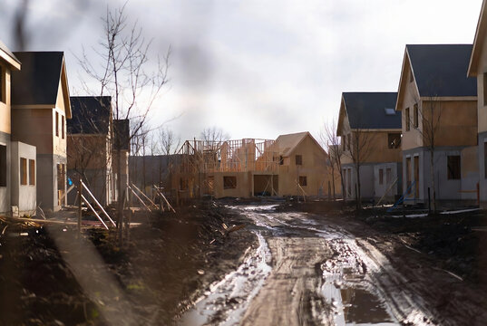 Construction site with new houses under construction in a residential development area.