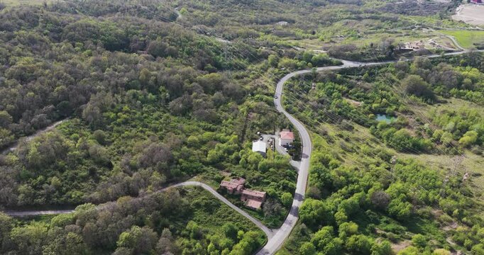 Aerial view of the winding road leading to the Enel Green Power geothermal plant in Larderello, Tuscany, Italy.