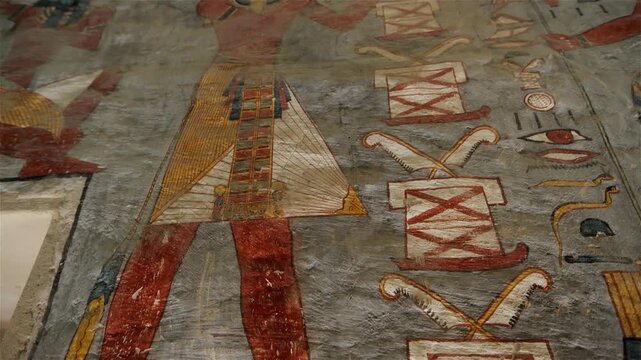 KV16 royal tomb of Ramesses I, Valley of the Kings, Luxor, Egypt, depicting processions of gods, mummiform figures and hieroglyphics on grey and golden walls.