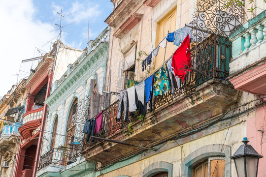 Cuba, Havana.  Laundry hanging out to dry on a residential balcony, high above the street.