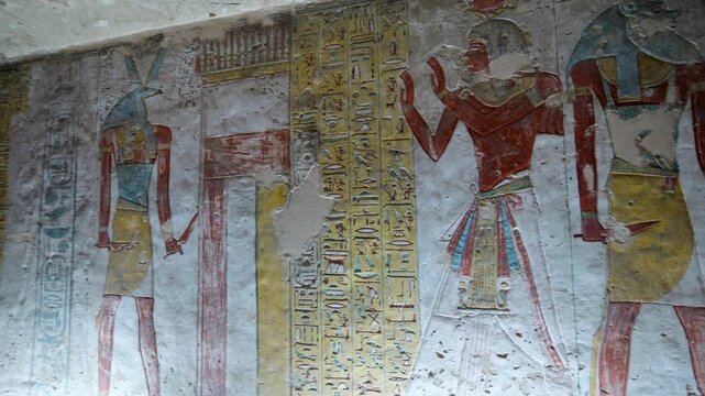 KV14 royal tomb, Valley of the Kings, Luxor, Egypt, with vivid Egyptian gods, winged goddess Isis, pharaoh figures, hieroglyphics on golden yellow walls.