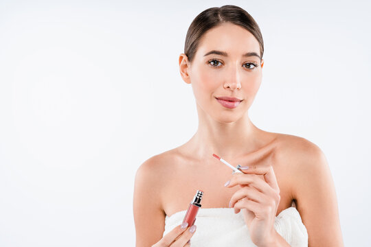 Portrait of beautiful young woman holding lip gloss isolated on white background, beauty makeup, cosmetic product, lip care, natural look and skincare routine concept copy space