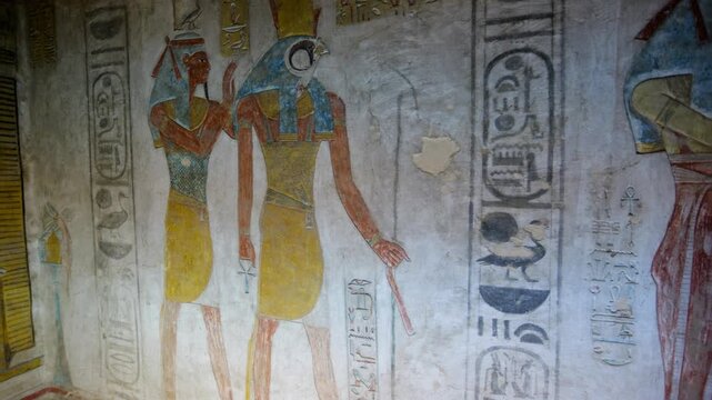 KV14 royal tomb, Valley of the Kings, Luxor, Egypt, with vivid Egyptian gods, winged goddess Isis, pharaoh figures, hieroglyphics on golden yellow walls.