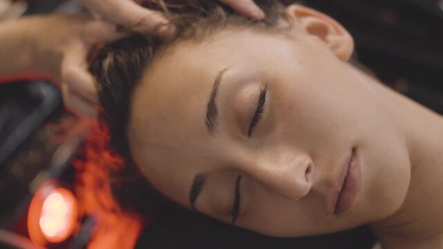 Woman enjoying a relaxing head spa scalp massage