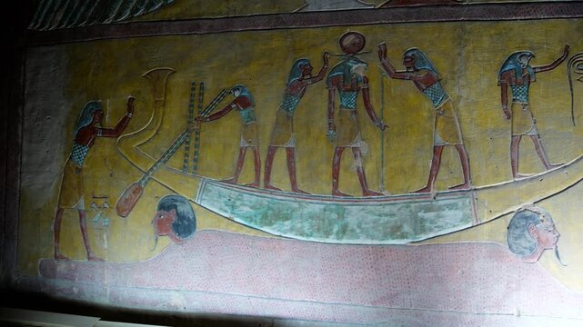 Burial chamber ofKV14 royal tomb, Valley of the Kings, Luxor, Egypt, with vivid Egyptian gods, winged goddess Isis, pharaoh figures, hieroglyphics on golden yellow walls.