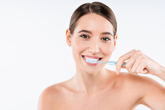 Beauty portrait of happy young woman brushing teeth with toothbrush isolated on white background, oral hygiene, dental care, fresh smile and wellness concept