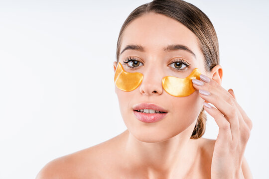 Portrait of beautiful woman with under eye patches isolated on white background, skincare treatment, eye care routine, hydration therapy, cosmetic beauty and wellness concept