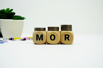 Stack of coins with wood blocks with "MOR (Minimum Overdraft Rate)" Financial concept © may1985