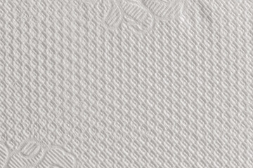 Obraz premium Macro texture of white woven textile or paper material with a fine regular grid dot embossed pattern. Tight weave structure gives a clean, uniform surface ideal for backgrounds.