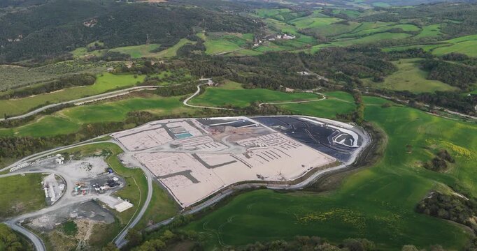 Larderello, Italy - 15 April 2026: Aerial view of Enel Green Power Centrale Geotermica di Larderello geothermal plant surrounded by rolling green hills and lush forests in Tuscany.