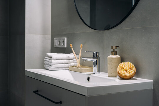 Modern bathroom with sink and hygiene items for daily routines