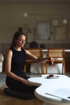 Elegant living room setting with a woman enjoying coffee at a white table