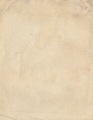 Fototapeta premium Softly textured light brown paper with gentle folds and subtle stains creating aged blank page background with organic feel and vintage document appearance showing wear and time effects.