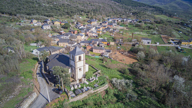 Aerial view from the church of Our Lady of the Assumption that crowns the town of San Juan de Paluezas above a barbican and a small cemetery next to the bell tower