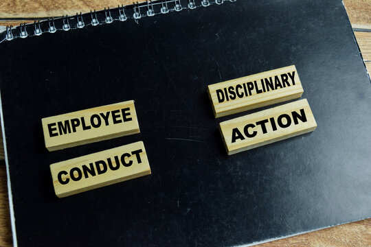 Concept of text employee conduct, disciplinary action on wooden blocks. For corporate policy, workplace ethics and HR management
