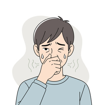 A man is covering his nose with his hand, indicating he is experiencing a bad smell or odor. He is sweating and looks disgusted.