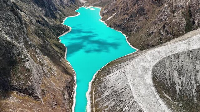 Aerial drone view of the turquoise waters of Laguna Par&oacute;n, with snow-capped peaks of the Cordillera Blanca in Huaraz, Peru.	