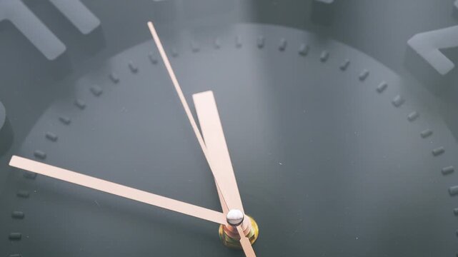 Golden second hand of a clock moving fast in a circle, time concept
