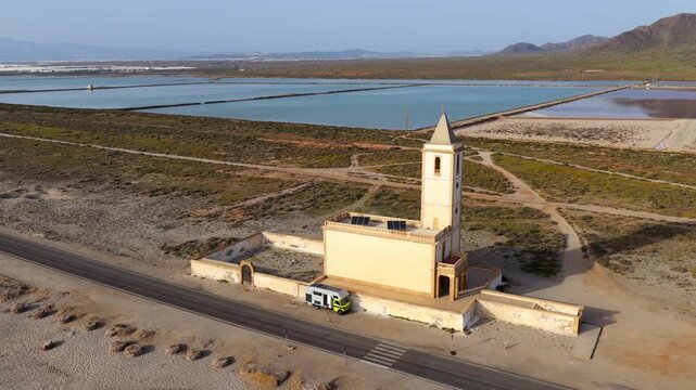 AERIAL - Church at beach, Cabo de Gata, Spain. Church of La Almadraba de Monteleva.